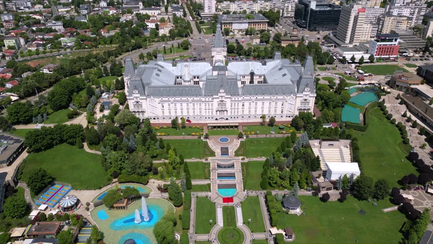 Aerial drone footage of the Iasi cultural palace in the city of Iasi in Romania at night. Beautiful palace of culture in moldavia. High angle flyover shot of sunny urban cityscape from above.