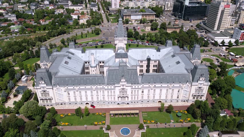 Aerial drone footage of the Iasi cultural palace in the city of Iasi in Romania at night. Beautiful palace of culture in moldavia. High angle flyover shot of sunny urban cityscape from above.