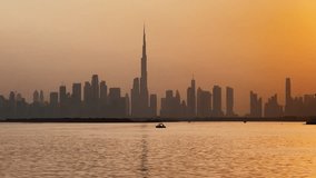 Cinematic Dubai skyline at sunset with boats in creek and bird flying, Vertical stock video 4k pro res 422 - Powered by Shutterstock - Get 15% off with code: PIKWIZARD15