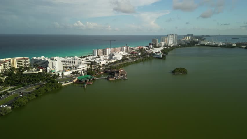 4K aerial view of Cancún Hotel Zone showing luxury hotels, sandy beach, and clear Caribbean waters