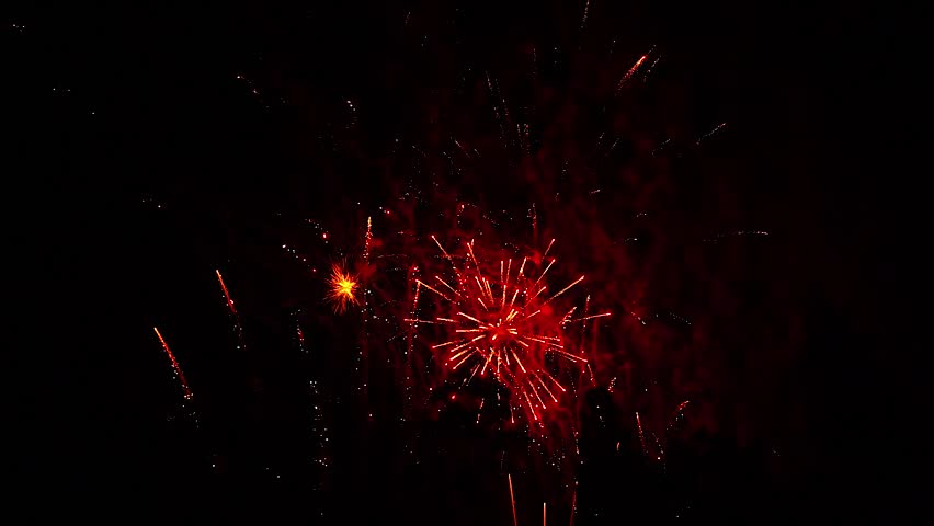 Colorful fireworks explode in night sky. Festival ending with fire show, firework. Festive event on city day, independence day. Sparks, arrows and flames from fireworks explosions fly off lighting sky