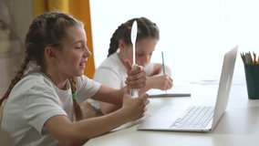 Girl learning online with laptop child at desk holding number card while doing homework and study during education classroom session with focused learning and participation by student and teamwork - Powered by Shutterstock - Get 15% off with code: PIKWIZARD15