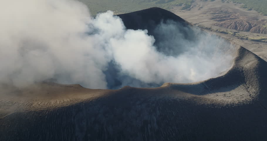 Tana Island: Aerial view Yasur Volcano releasing a massive plume of smoke and ash, showcasing the dramatic natural power, Vanuatu. Wild nature travel landscape. Drone flight footage