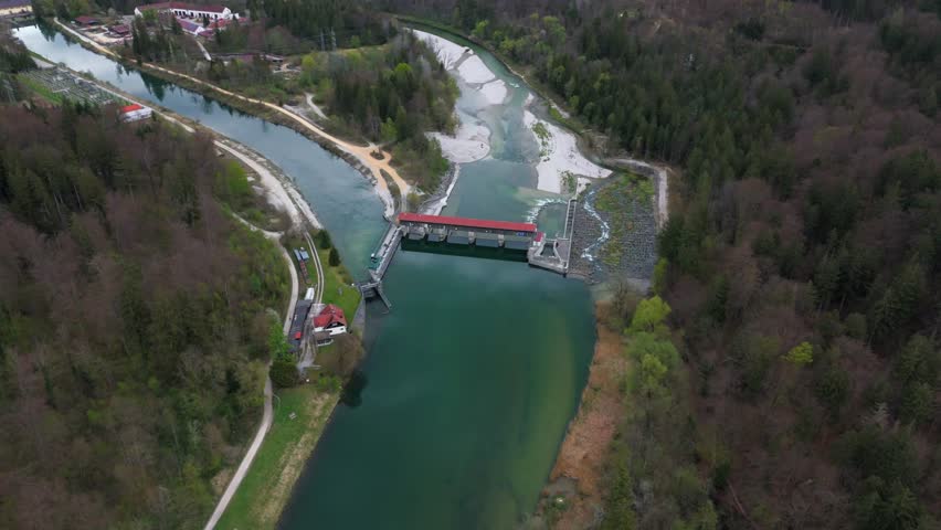 Drone footage of Baierbrunn weir, VLH turbine, and fish pass on the Isar River, Bavaria, Germany. Innovative hydropower, green energy, sustainable technology, and water engineering. Fischtreppe. 
