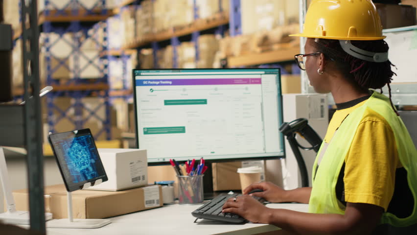 Black warehouse worker managing inventory logistics with AI virtual assistant to help updating shipping labels for accurate delivery and order processing. Online shopping retail activity. Camera B.