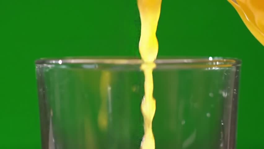 Orange juice being poured into glass