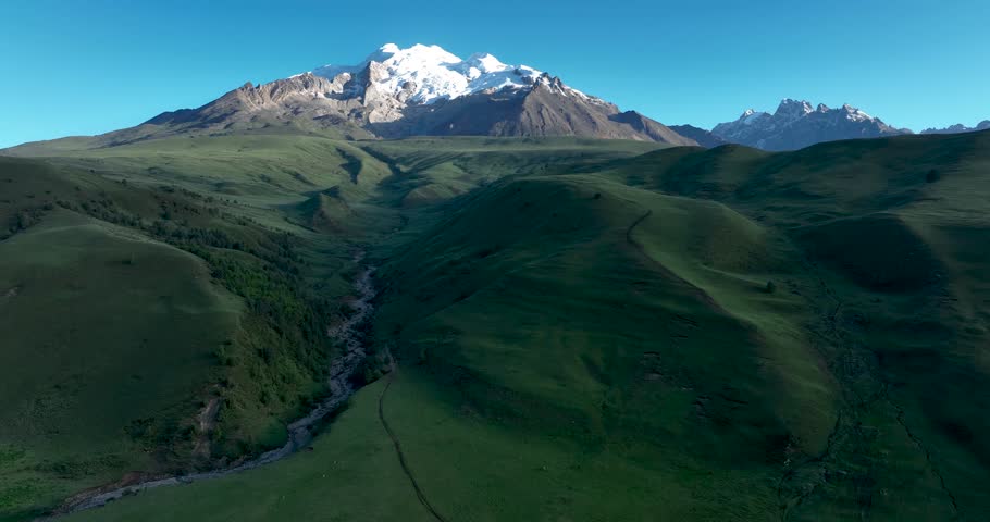 Beautiful green grassland and snow capped mountain in Litang county, China