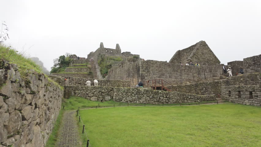 Slow motion video of Inca stone structures inside Machu Picchu, showing ancient walls and architecture in Peru