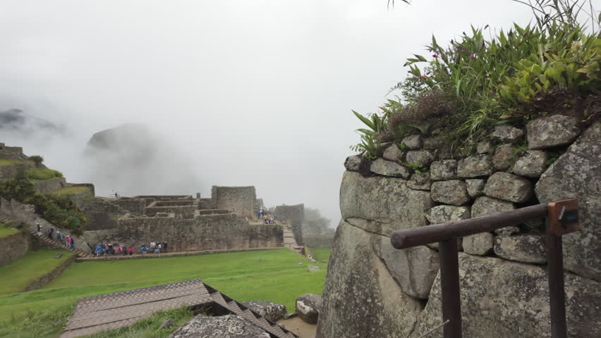 Slow motion video of Inca stone structures inside Machu Picchu, showing ancient walls and architecture in Peru
