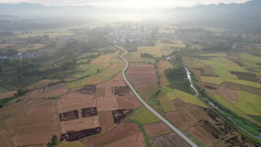 Drone view villages and farmlands among green mountains, high angel view rural landscape in autumn day, 4k real time footage b roll shot, Nanping village, Yixian, Anhui, China