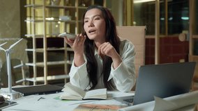 Asian business girl woman female Chinese send message audio mobile phone talking in office record voice mail speakerphone Korean Japanese businesswoman speak to mic architect engineering company call - Powered by Shutterstock - Get 15% off with code: PIKWIZARD15
