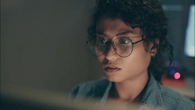 Close-up face of a female programmer wearing glasses working late at night, coding artificial intelligence with deep focus, highlighting cybersecurity, digital security, and technology development. - Powered by Shutterstock - Get 15% off with code: PIKWIZARD15
