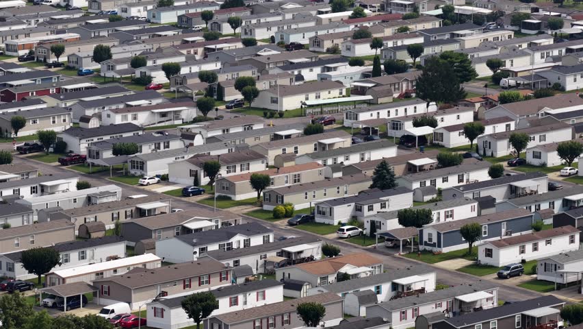 Overhead aerial of neighborhood streets in Indiana with lush green lawns and clean streets.