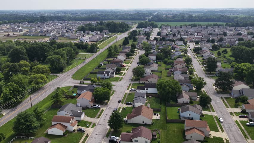 High aerial overview of a large Indiana neighborhood in the middle of farm land.