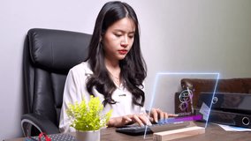 Asian woman working with futuristic augmented reality interface, using virtual AI assistant technology for online business and smart home control on a holographic screen. - Powered by Shutterstock - Get 15% off with code: PIKWIZARD15