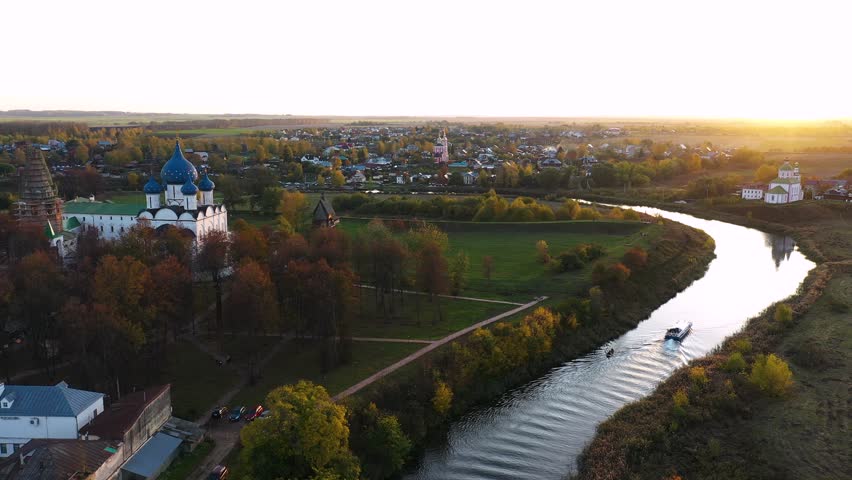 Suzdal kremlin and kamenka river in golden sunset light at autumn, Aerial view