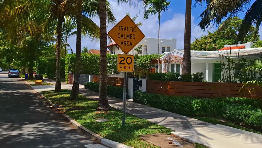 Street sign marking traffic calmed area at 20 mph in tropical residential neighborhood
