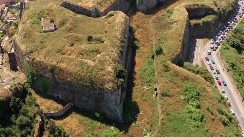 Captivating aerial footage showcasing the ancient walls and strategic location of a historic fortress on Corfu Island, Greece.