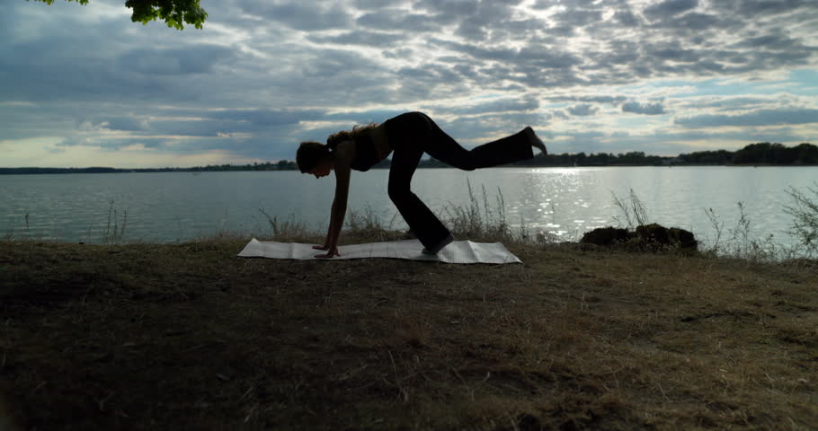 Engaging in Graceful Yoga Poses by the Tranquil Water Enhances Mindfulness and Wellbeing