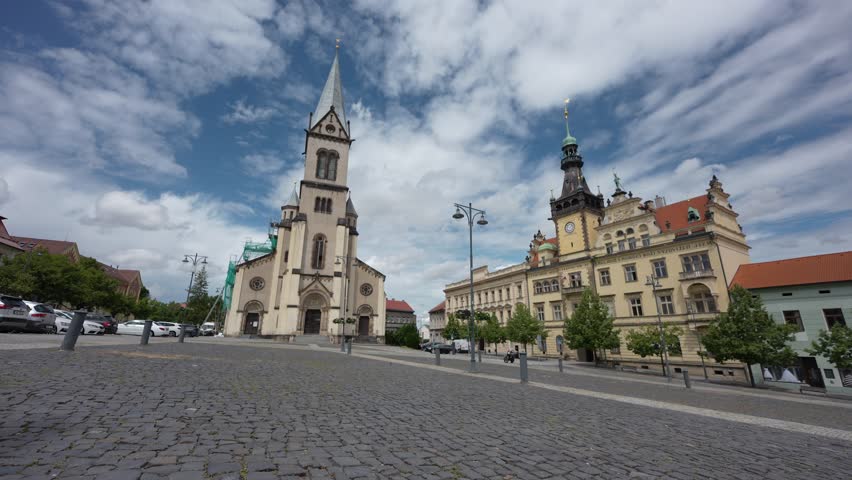 square in Kladno city, Czechia, Europe with town hall, church, blue sky with clouds
