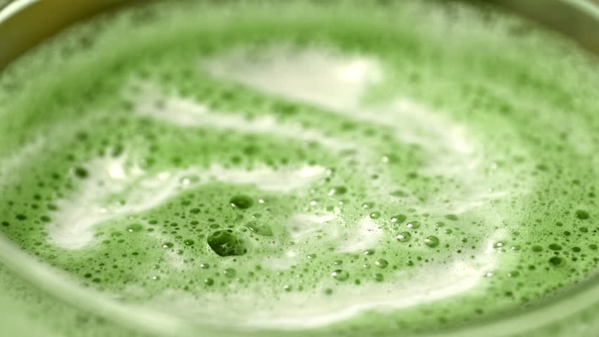 Super Slow Motion Detail Shot of Pouring Milk into Matcha Latte with Camera Motion at 1000fps.