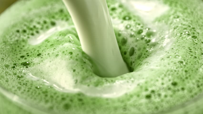 Super Slow Motion Detail Shot of Pouring Milk into Matcha Latte with Camera Motion at 1000fps.