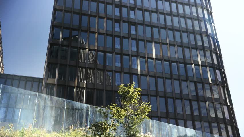 Focused business woman in black suit typing on laptop keyboard at remote workplace oudoors on public steps. Portrait of female professional working calm in city hustle.