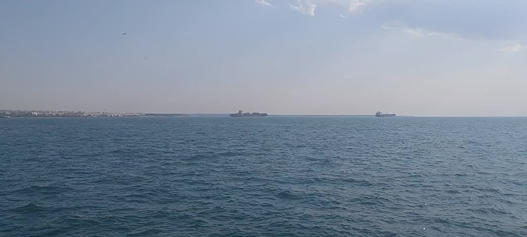 Aerial and panoramic view of Thessaloniki harbor with the Aegean Sea and coastal landscape. Beautiful seascape with city skyline, harbor area, and tranquil bay waters in northern Greece.