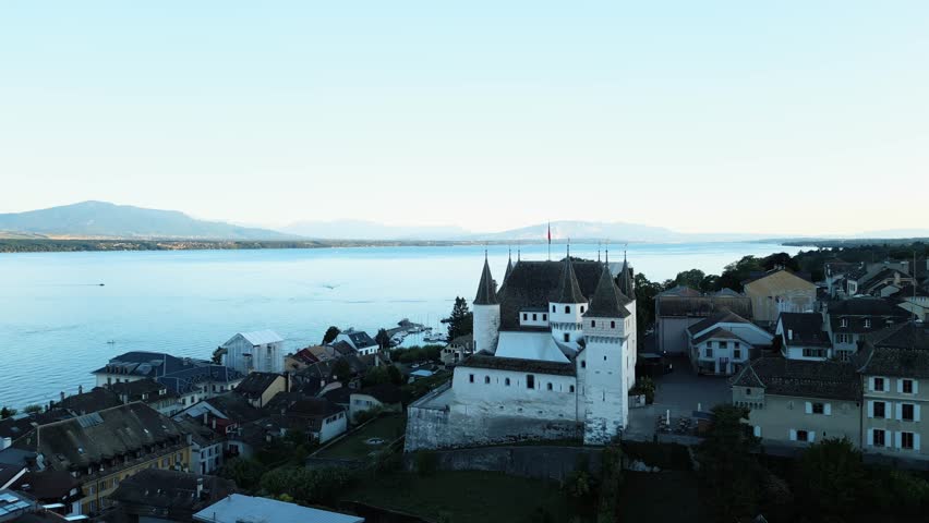 Aerial view of Château de Nyon with its imposing architecture, overlooks the serene waters, a contrast of history and nature, Nyon, Vaud, Switzerland.