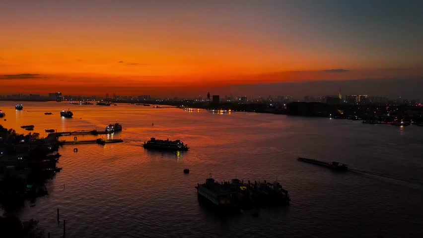 Aerial sunset view of Cat Lai port with cargo ship and container. Large import and export port important for economic development in Ho Chi Minh City, Vietnam