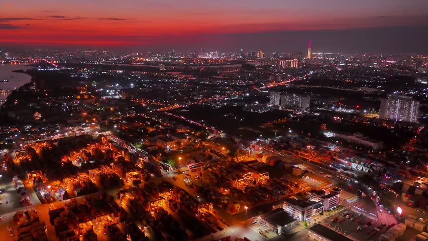 Aerial sunset view of Cat Lai port with cargo ship and container. Large import and export port important for economic development in Ho Chi Minh City, Vietnam