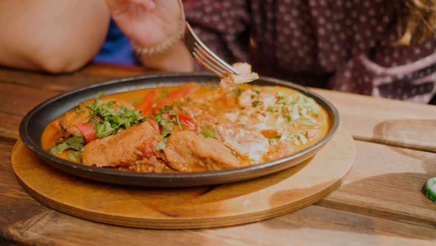 Savory lagman is presented with chunks of beef colorful vegetables and a touch of chili pepper showcasing a hearty dish perfect for a warm meal