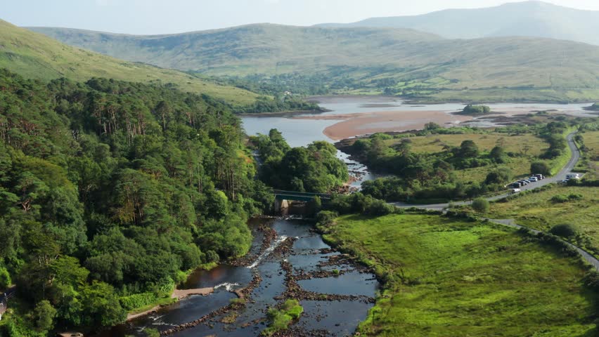Aerial View of Aasleagh Falls River Flowing Through Forest, Meadows, and Scenic Roads with Cars Parked Nearby