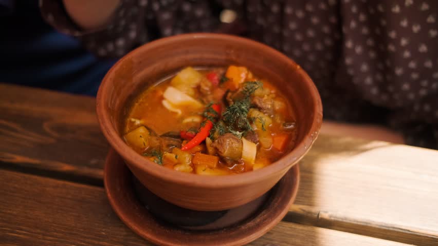 Savory lagman is presented with chunks of beef colorful vegetables and a touch of chili pepper showcasing a hearty dish perfect for a warm meal