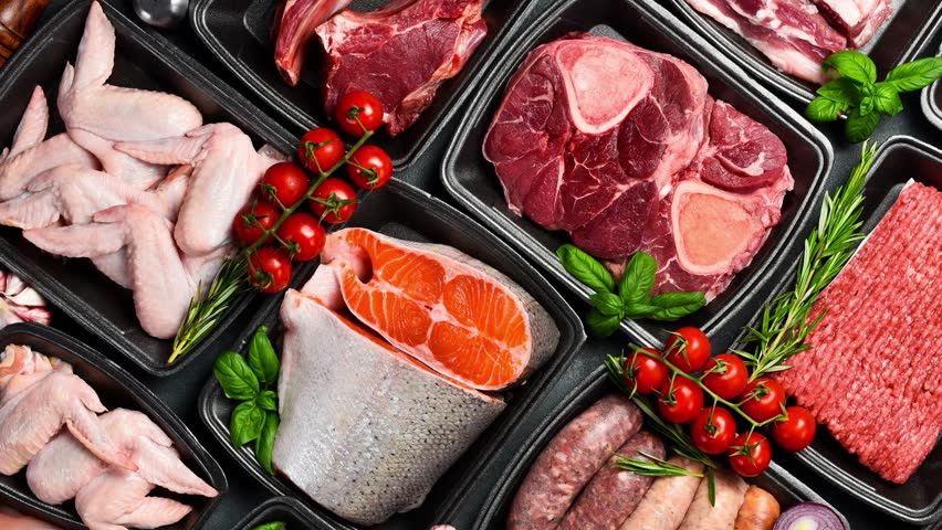 Raw fresh meat and fish in Black plastic packaging trays from supermarket. Top view. Food background.