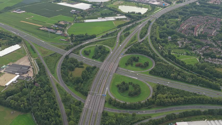 Drone overview of dynamic highway crossroads with traffic in motion