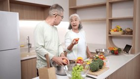 Elder Asian couple enjoys cooking fresh vegetables in their bright modern kitchen. They prepare a nutritious healthy meal together. This domestic scene portrays happy lifestyle. - Powered by Shutterstock - Get 15% off with code: PIKWIZARD15