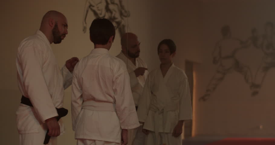 Instructor motivates young student to develop karate skills