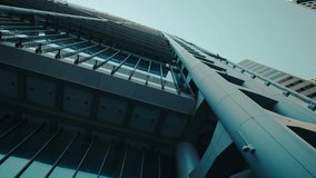Dynamic upward perspective of a futuristic skyscraper with steel beams and architectural details. Modern urban business center symbolizing innovation, strength, and financial growth. - Powered by Shutterstock - Get 15% off with code: PIKWIZARD15
