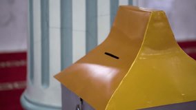 A man puts money into a mosque's donation box. - Powered by Shutterstock - Get 15% off with code: PIKWIZARD15