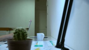 A woman is seated at a home office desk, focused on her laptop. The workspace includes documents and a plant, creating a cozy and productive environment. - Powered by Shutterstock - Get 15% off with code: PIKWIZARD15