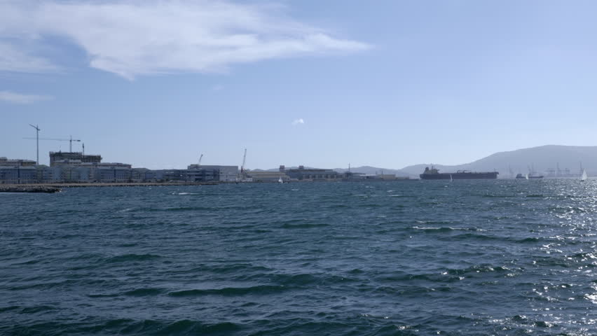 Pan from the Algeciras bay towards the rock of Gibraltar, as seen from La Linea de la Concepcion in Spain.
