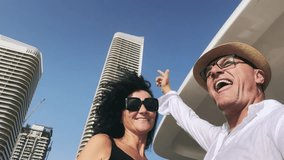 Cheerful business couple dance smiling cruising on luxury yacht in front of modern skyscrapers in Dubai Marina - Powered by Shutterstock - Get 15% off with code: PIKWIZARD15