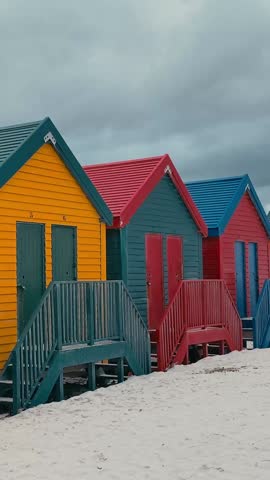 Colorful beach houses at Muizenberg beach Cape Town, Beach huts. Vertical video