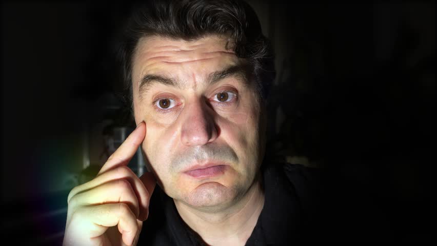 Handsome man expressing surprise emotion. Face close-up. Bright lighting.
