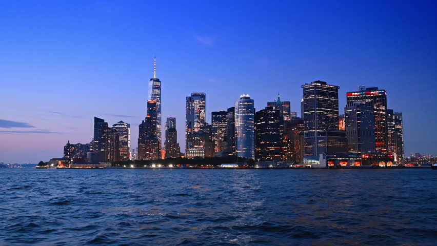 Fabulous Manhattan with dazzling illumination at night. View on New York skyline from the riverscape.