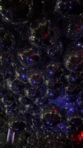 Silver balloons floating in an indoor room with festive atmosphere