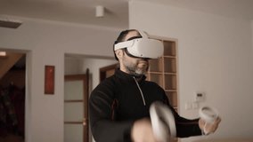 Man on Virtual Reality Glasses Doing Variation of Online Fitness Training. Man Wearing Virtual Reality Headset Holding Gaming Controllers. Sportsman in VR Headset Working Out at Home. Metaverse Oculus - Powered by Shutterstock - Get 15% off with code: PIKWIZARD15