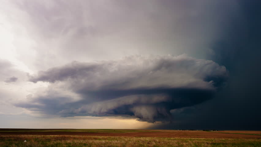 Dangerous weather nears as a severe thunderstorm looms overhead, with dark swirling clouds and the threat of lightning creating a tense and dramatic atmosphere