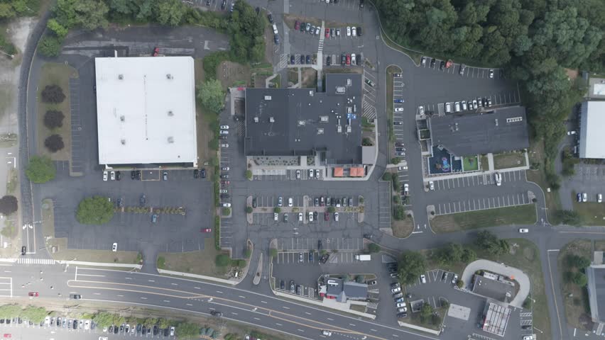 Aerial zoom over Brookfield CT showcasing scenic town views, lush greenery, suburban charm, and New England architecture. Ideal for travel, real estate, or local promo use.